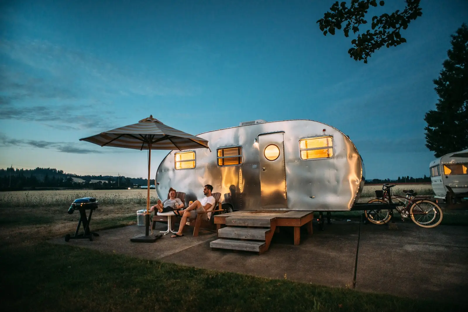 Couple sitting outside a caravan